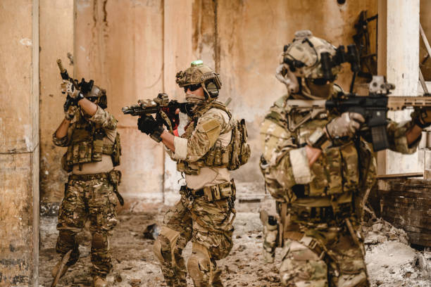 istock Expert team of soldiers with weapons attacking enemy 1496319699