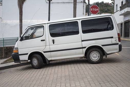 Tirajana, Spain – May 28, 2023: A view of an old white Toyota Hiace van parked outdoors