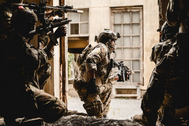 istock Expert team of soldiers attacking enemy during military operation 1496319908