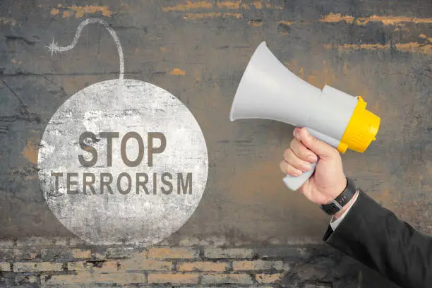 Photo of Businessman showing stop terrorism sign