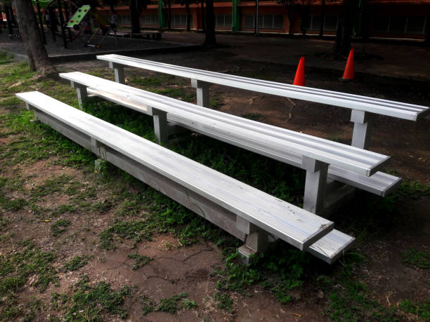 A large area of metal bleachers seating with a covered section.