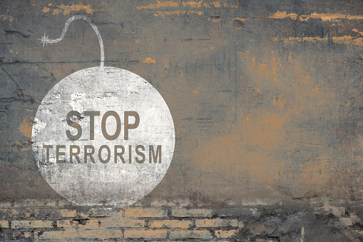 Bricked wall with stop terrorism sign