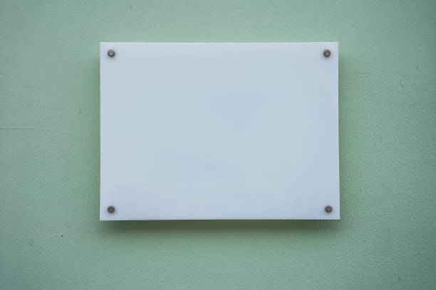 White nameplate on spacer metal holders mounted on office building
