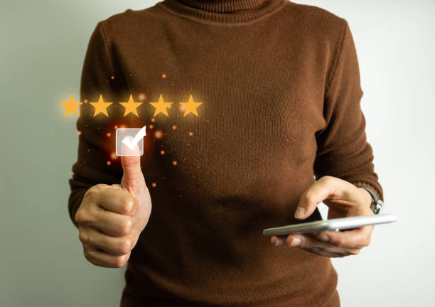 istock Businessman rate satisfaction 5 stars by smartphone, Excellent quality assurance, certification the best service, guarantee standard company's service. ISO certification, satisfaction of customer. 1496325196