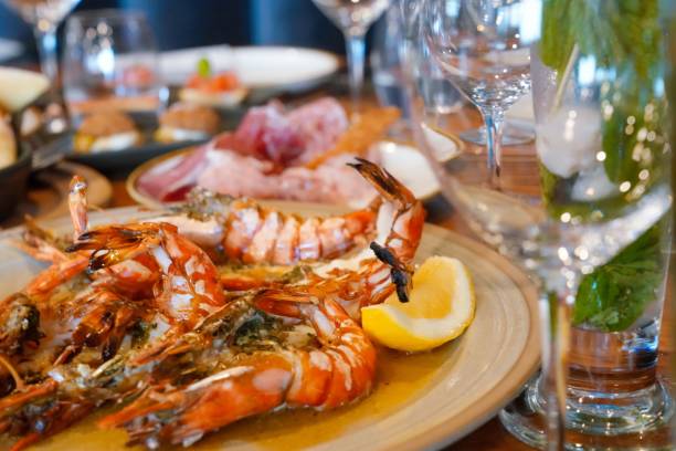 istock Plate of delicious grilled tiger prawns and assorted vegetables 1496326183