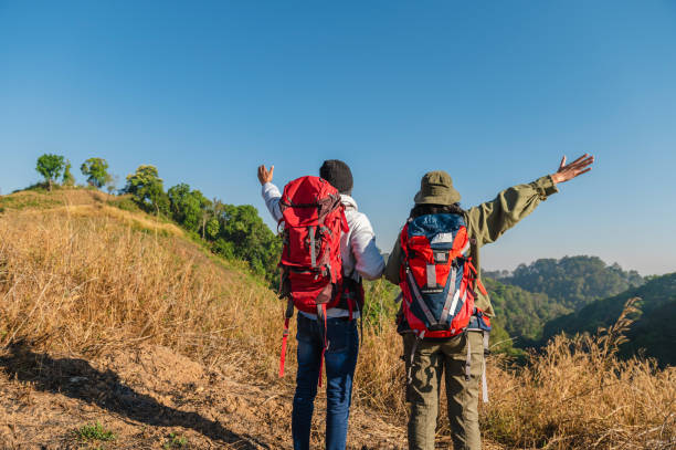 istock traveler couple with backpack standing looking view on mountain 1496326995