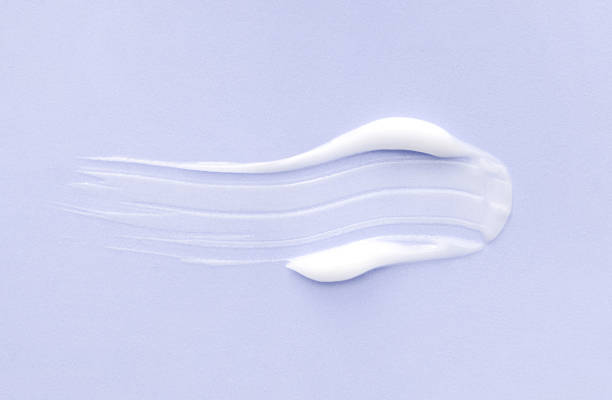 istock cosmetic smears cream texture on pastel purple background 1496327554