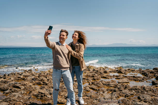 istock Young Couple Taking Selfies On The Beach In Greece 1496330712