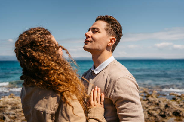 istock Young Couple Embracing On The Beach In Greece 1496332342