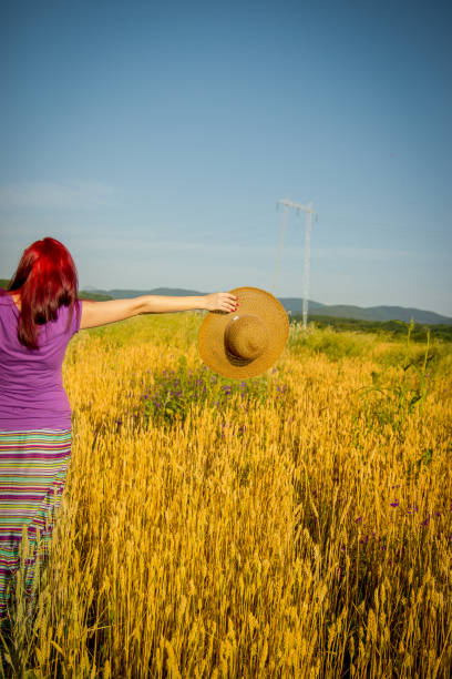 Beautiful redhead girl at meadow