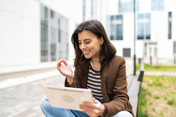 istock Adult student holding digital tablet in her hands 1496333044