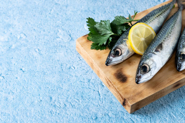 istock Raw mackerel fish salt around on blue background 1496335636
