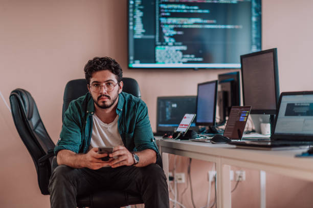 A programmer diligently testing smartphone applications while sitting in their office. A programmer diligently testing smartphone applications while sitting in their office. High quality photo checking ice hockey stock pictures, royalty-free photos & images