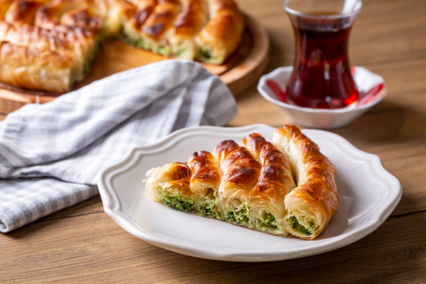 Traditional Turkish pastry with spinach. (Turkish Name: Ispanakli Kol Boregi, Bosnak boregi). Handmade pastry with spinach filling.