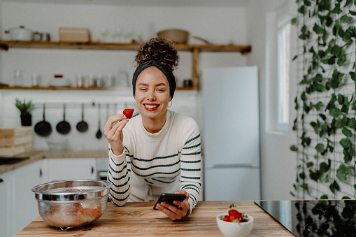 Young woman eating strawberries