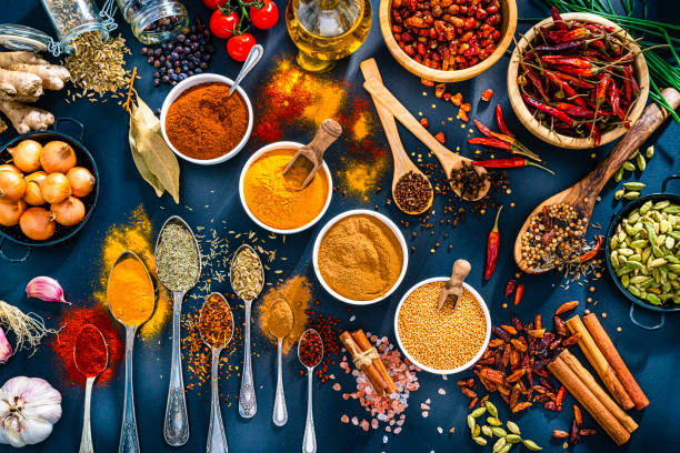 istock Spices, herbs and condiments on blue background. 1496340342