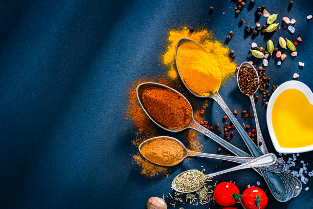 istock Spoons full of spices on blue background. 1496340348