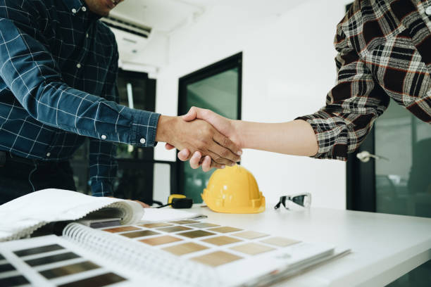 istock Engineers, designers and interior designers are handshake shack hands deal finalizing the design of interiors by discussing selecting materials and colors to design rooms to present to clients. 1496341337