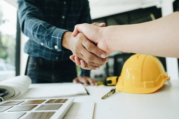 istock Engineers, designers and interior designers are handshake shack hands deal finalizing the design of interiors by discussing selecting materials and colors to design rooms to present to clients. 1496341409