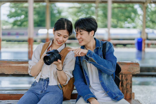 istock Young couple traveling using a camera to capture memories while waiting for the train at the station.travel concepts. 1496342395