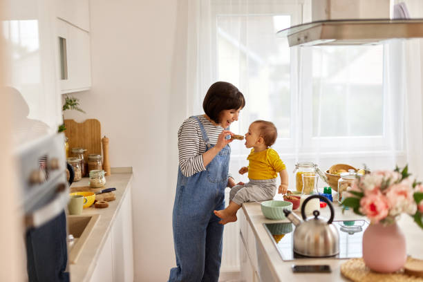 istock Mother feeding baby boy in the kitchen 1496346325