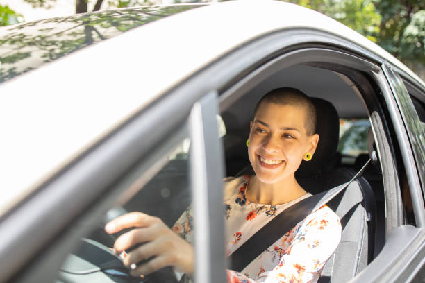 istock Young woman is driving a car 1496347137