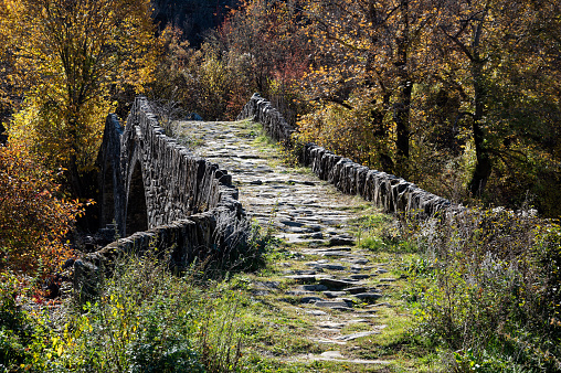 View of the traditional stone Mylos Bridge in Epirus, Greece in Autumn