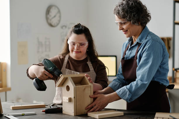 istock Girl using drill to make birdhouse 1496349018