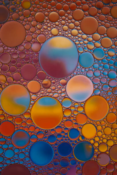 istock multi colored oil circles on the water, colorful background 1496349370