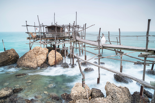 Traditional fishing machine in Abruzzo, Italy: the trabocco. It is a structural wooden construction made up of a platform lying on the sea anchored to the rock by large trunks of Aleppo pine.