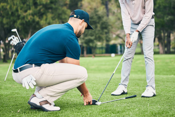 istock Teaching, golf lesson and sports coach help man with swing, driver or stroke outdoor. Coaching, course and club support of athlete men ready to start golfing exercise, workout and training for game. 1496362094