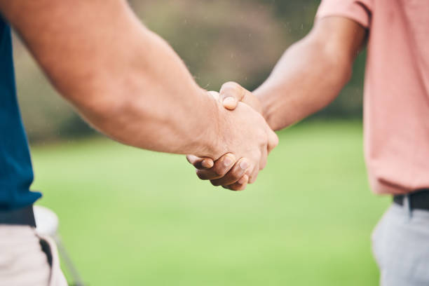istock People, handshake and sport for partnership, trust or unity in community, collaboration or teamwork on grass field. Team of sporty players shaking hands on golf course for club, game or outdoor match 1496362134