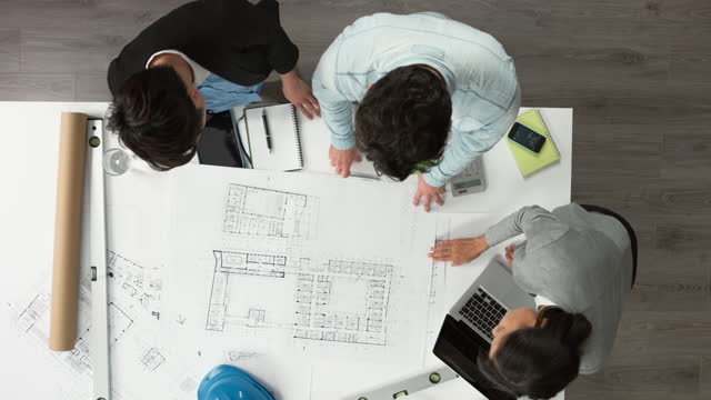 Architect plans arial view business meeting showing teamwork