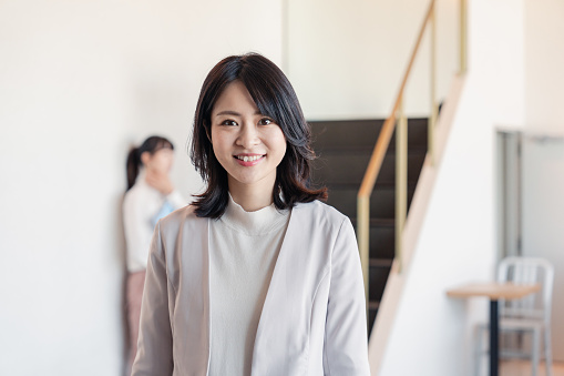 Female manager walking in her office with a smile