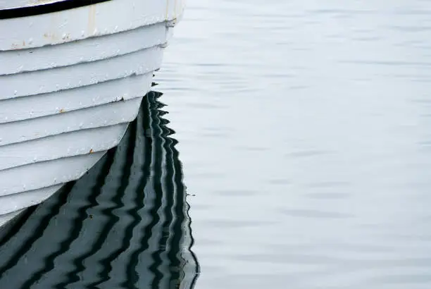 A small boat is reflected in the sea at Iceland