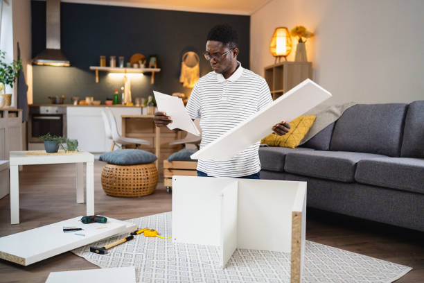 istock African-American reading instruction manual while man assembling new furniture in the apartment 1496368950