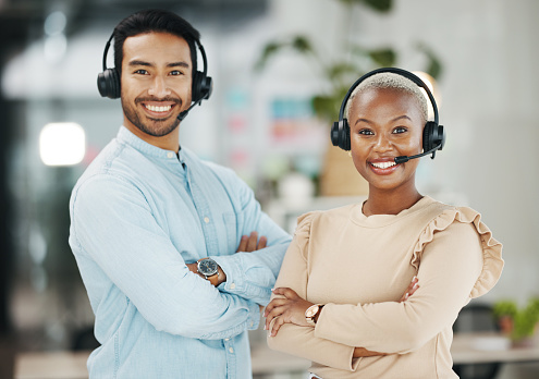Business people, call center and portrait smile with arms crossed for teamwork collaboration in customer service at the office. Happy asian man and black woman consultant smiling for online advice