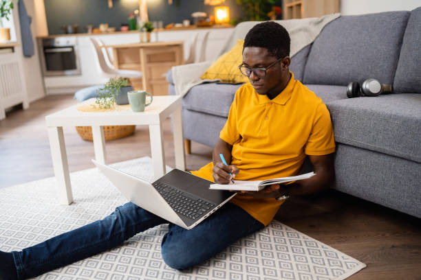 istock African-American male student e-learning at modern college dorm 1496370464