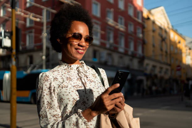 istock Female tourist walking on a sunny day, using a mobile phone. 1496372121