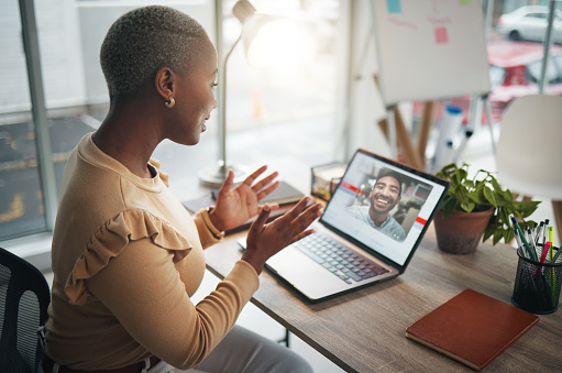Laptop, video call and a business black woman in her office, talking during a virtual meeting with a colleague. Computer, internet and webinar with a female employee chatting online to a coworker