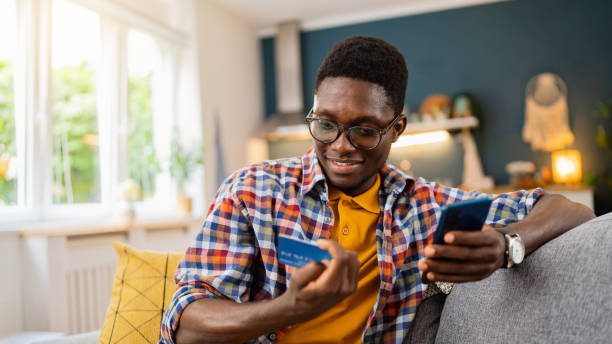 African-American man using mobile phone for online shopping