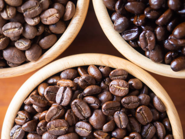 istock brown arabica coffee bean roast 3 level medium to dark different taste seed caffeine espresso drink food cafe beverage Chiang Rai, Thailand coffee on wooden table background top view selected focus 1496374931