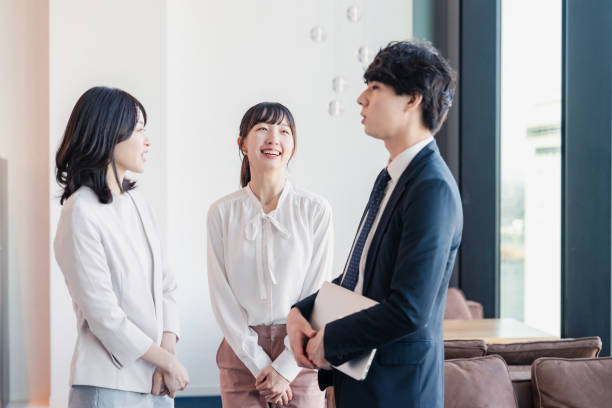 istock Young businesspeople talking friendly in an office 1496375102