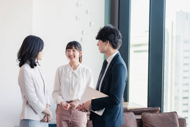 istock Young businesspeople talking friendly in an office 1496375105