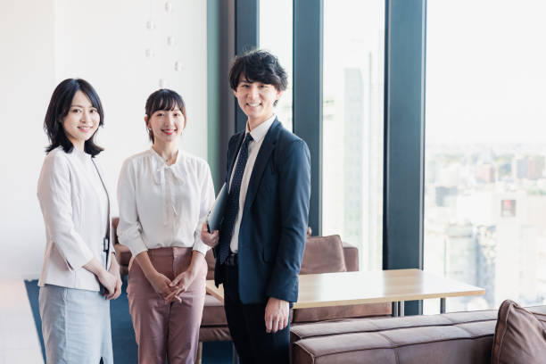istock Young businesspeople talking friendly in an office 1496375115