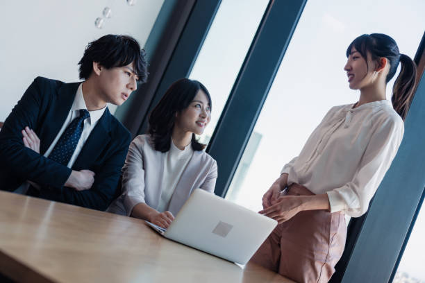 istock Young businesspeople talking friendly in an office 1496375128
