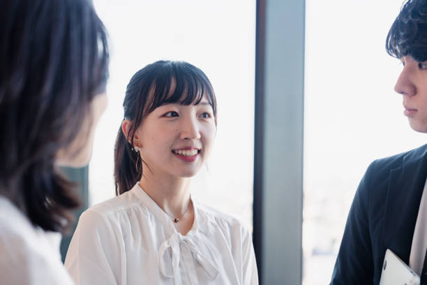 istock Young businesspeople talking friendly in an office 1496375129