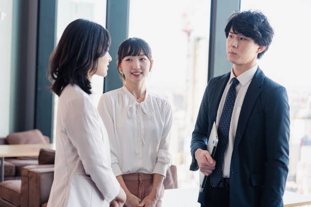 istock Young businesspeople talking friendly in an office 1496375135