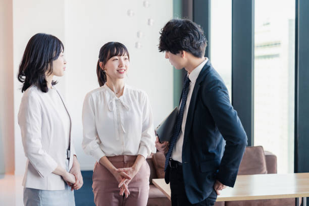 istock Young businesspeople talking friendly in an office 1496375144