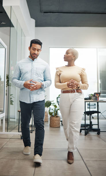 istock Business people walking, planning and discussion for startup strategy, project development or management in office. Diversity employees or black woman and partner discussion, advice or talking ideas 1496375300